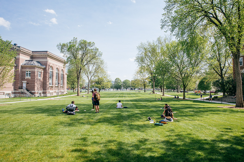 Students sit outside Baker Library